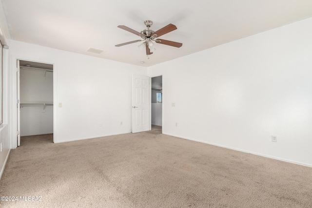 unfurnished bedroom with carpet flooring, ceiling fan, and a closet