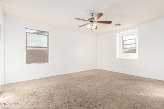 spare room featuring carpet floors and ceiling fan