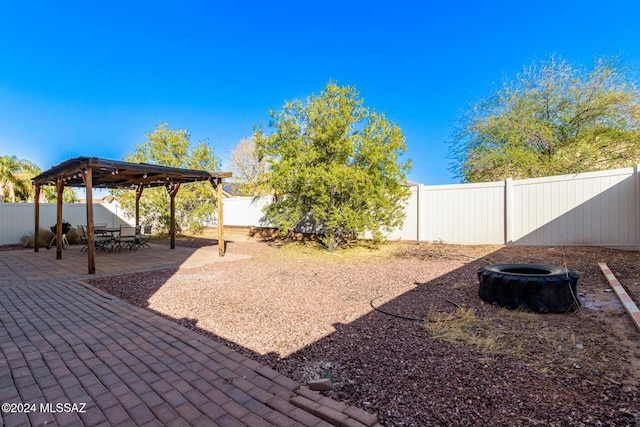 view of yard with a patio area, a pergola, and an outdoor fire pit