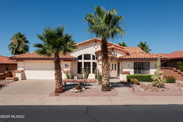 mediterranean / spanish house featuring a garage