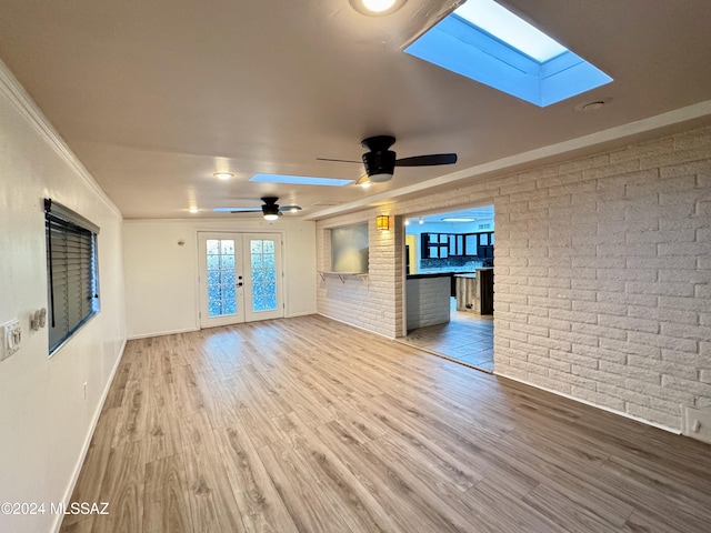 unfurnished living room with ceiling fan, french doors, ornamental molding, and light hardwood / wood-style flooring