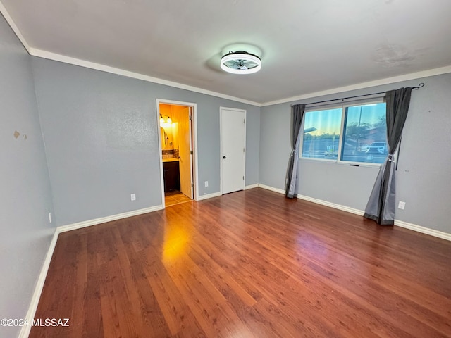 interior space with ornamental molding and hardwood / wood-style flooring