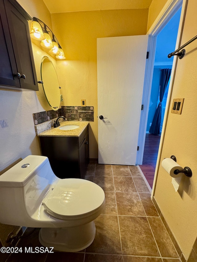 bathroom featuring toilet, vanity, and tile patterned floors