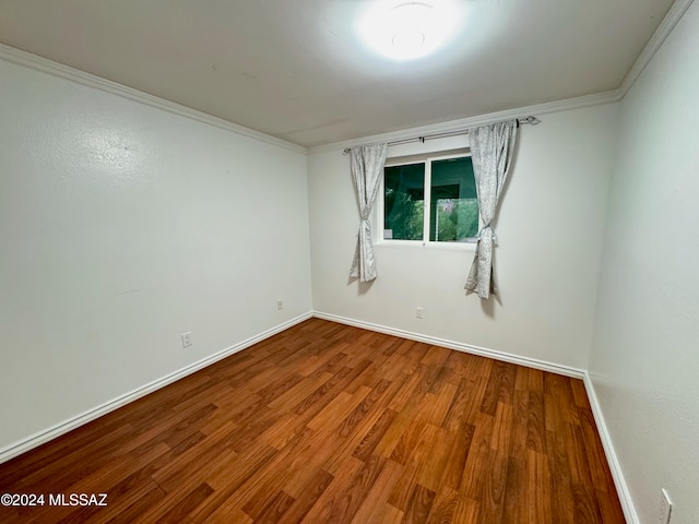 unfurnished room with hardwood / wood-style flooring and ornamental molding