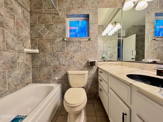 full bathroom with tile patterned flooring,  shower combination, toilet, vanity, and tile walls