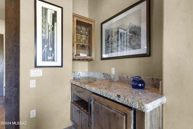 bar featuring light stone countertops