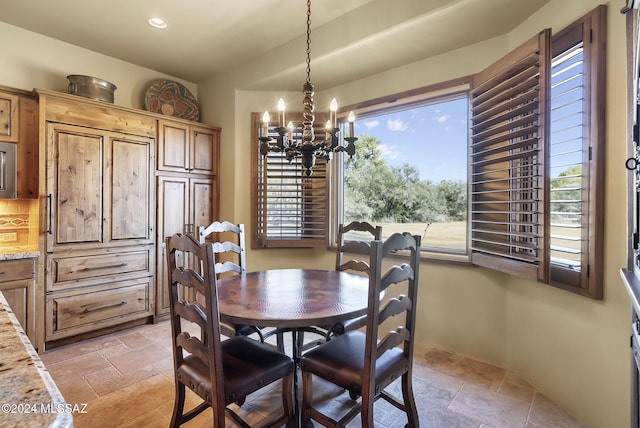 dining space featuring a healthy amount of sunlight and a notable chandelier