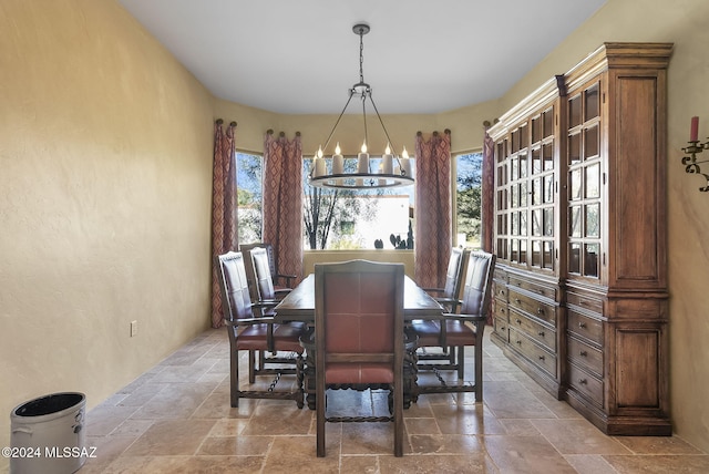 dining area featuring a wealth of natural light and a chandelier