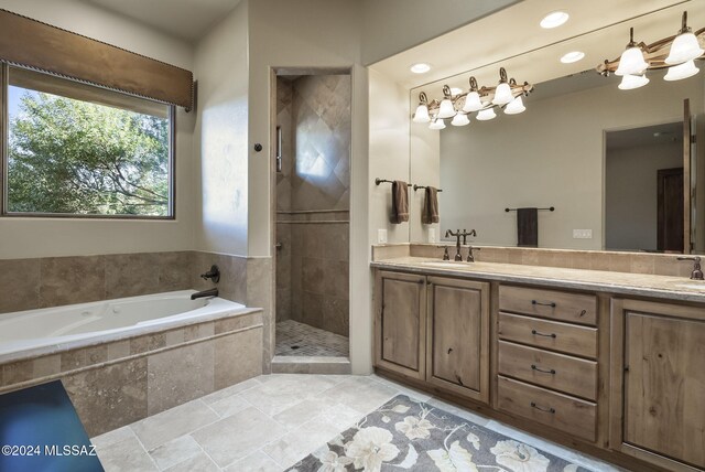 bathroom with vanity and separate shower and tub