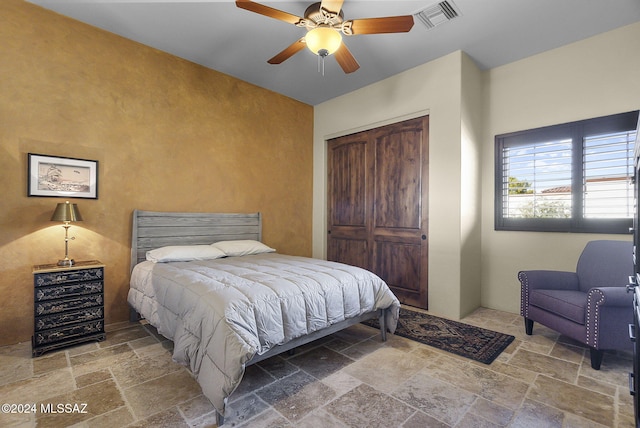 bedroom with ceiling fan and a closet