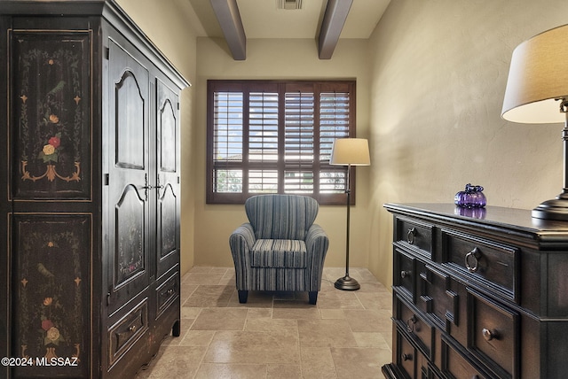 living area featuring beam ceiling