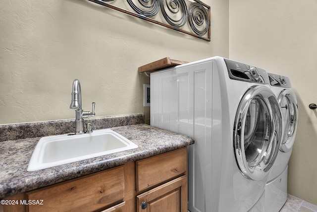 washroom with sink and washing machine and clothes dryer