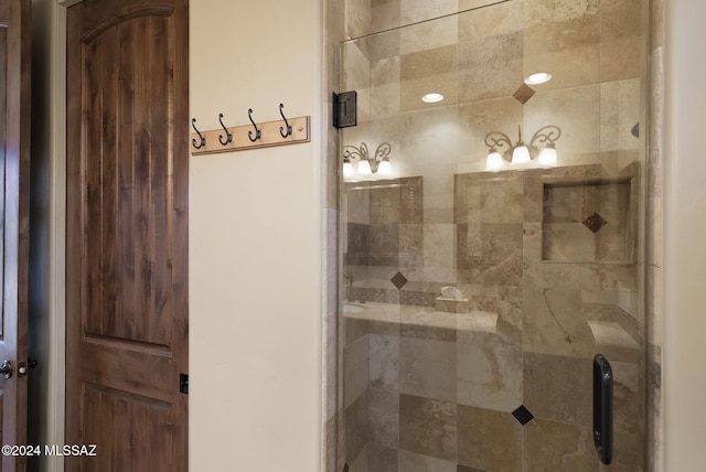 bathroom featuring a shower with door