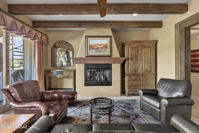 living room with beam ceiling and a fireplace