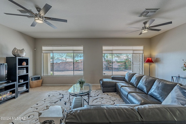 living room featuring a textured ceiling and light tile patterned flooring