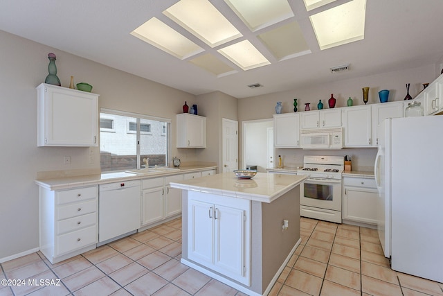 kitchen featuring white cabinetry, a center island, sink, white appliances, and light tile patterned floors