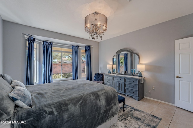 bedroom with light tile patterned floors and a notable chandelier