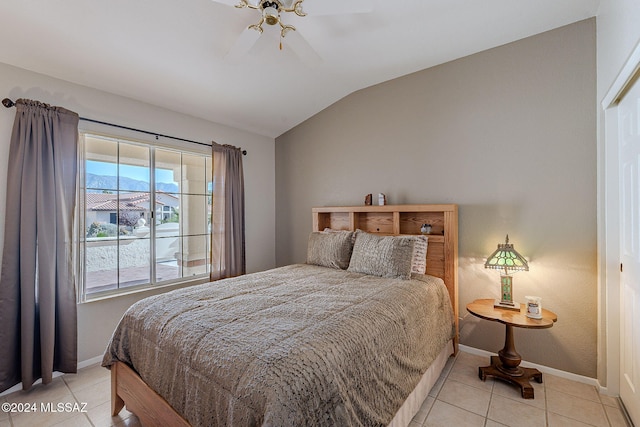 tiled bedroom with ceiling fan and vaulted ceiling