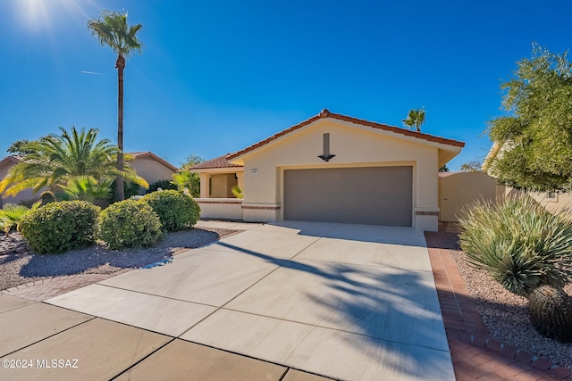 mediterranean / spanish home featuring a garage