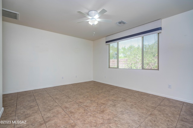 spare room featuring light tile patterned flooring and ceiling fan