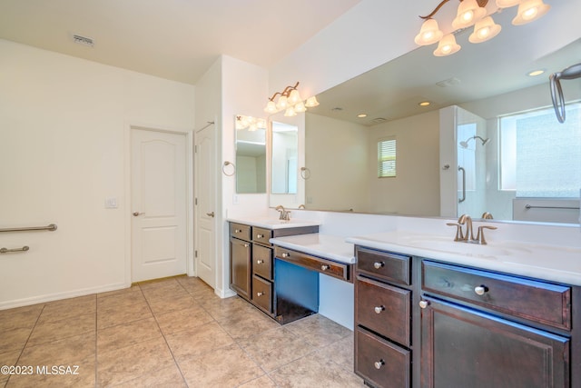 bathroom featuring tiled shower and vanity