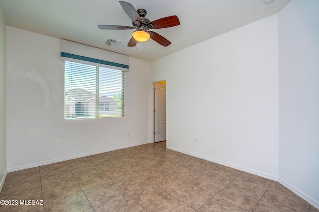 spare room featuring ceiling fan and light tile patterned flooring