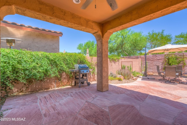 view of patio / terrace with ceiling fan and a grill