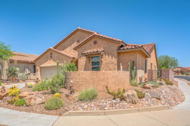 mediterranean / spanish-style home featuring a garage