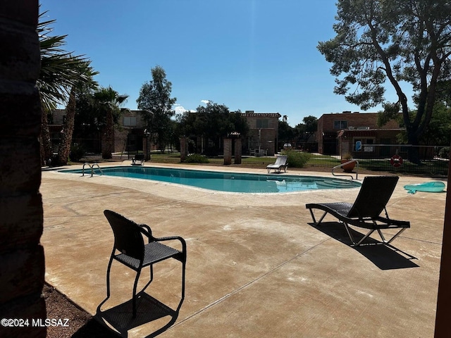 view of swimming pool featuring a patio area