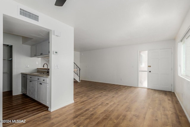 interior space with sink, dark wood-type flooring, and gray cabinets