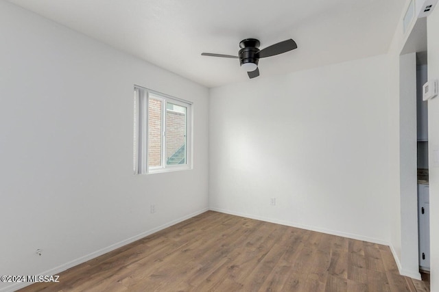 empty room featuring ceiling fan and light hardwood / wood-style floors