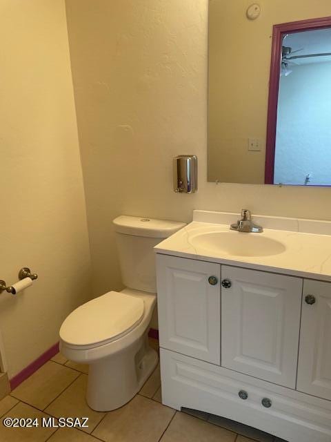 bathroom featuring tile patterned flooring, vanity, and toilet