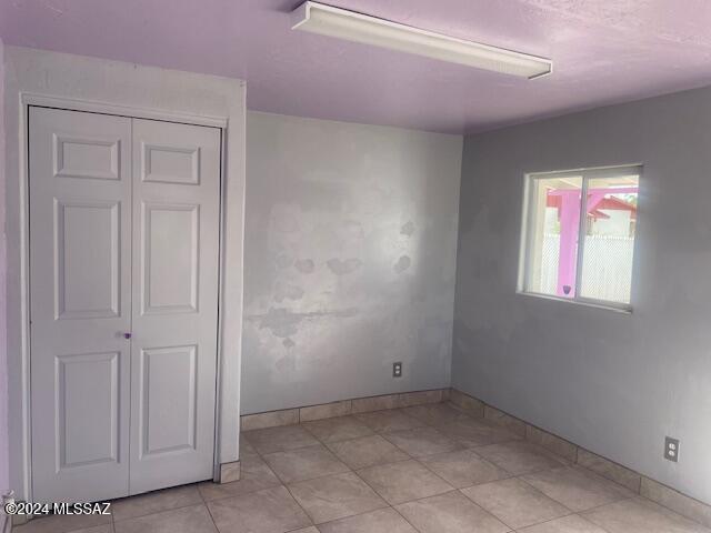 home office featuring an AC wall unit and light tile patterned flooring