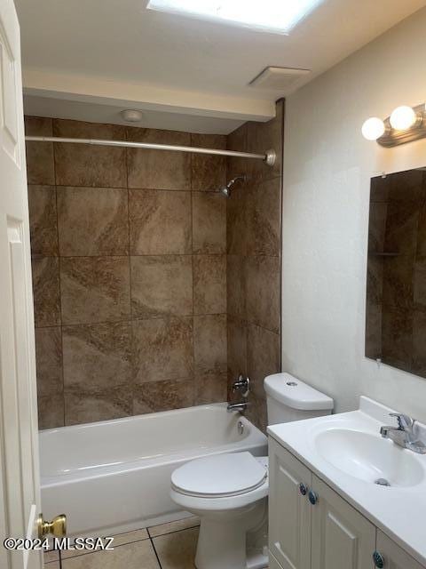 full bathroom featuring tile patterned flooring, vanity, toilet, and tiled shower / bath