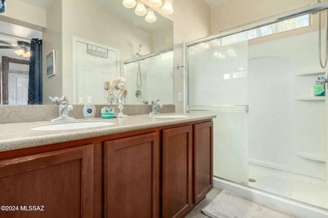 bathroom with vanity, ceiling fan, and an enclosed shower