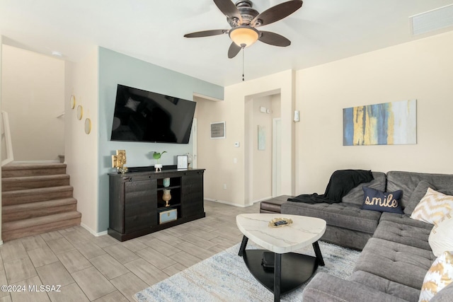 living room featuring ceiling fan and light hardwood / wood-style floors