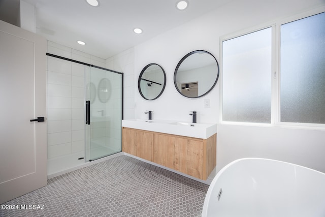 bathroom with vanity, a wealth of natural light, and independent shower and bath