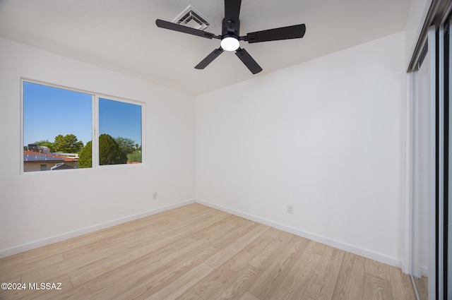 spare room featuring light hardwood / wood-style floors and ceiling fan