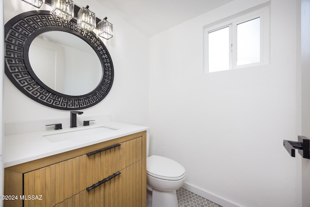 bathroom with tile patterned flooring, vanity, and toilet