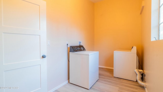 washroom featuring washer and dryer and light hardwood / wood-style flooring