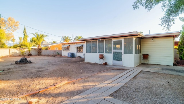 view of front of property with a patio area and cooling unit