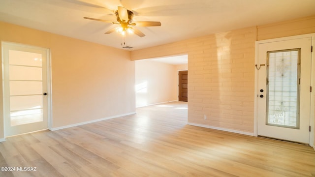 empty room with ceiling fan and light wood-type flooring