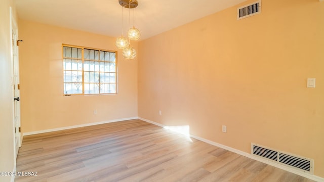 unfurnished room with light hardwood / wood-style flooring