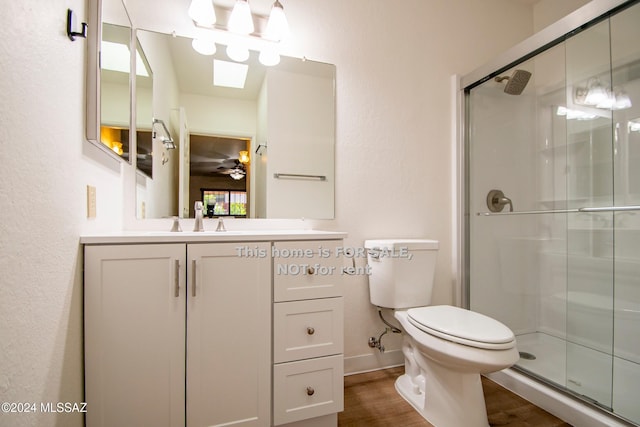 full bathroom with toilet, a stall shower, wood finished floors, and vanity