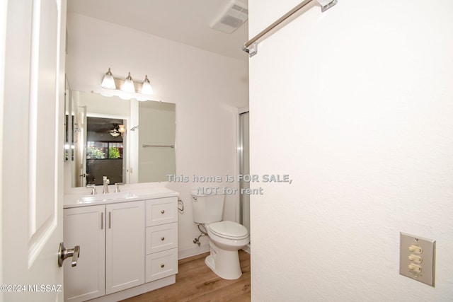 full bathroom featuring visible vents, toilet, ceiling fan, wood finished floors, and vanity