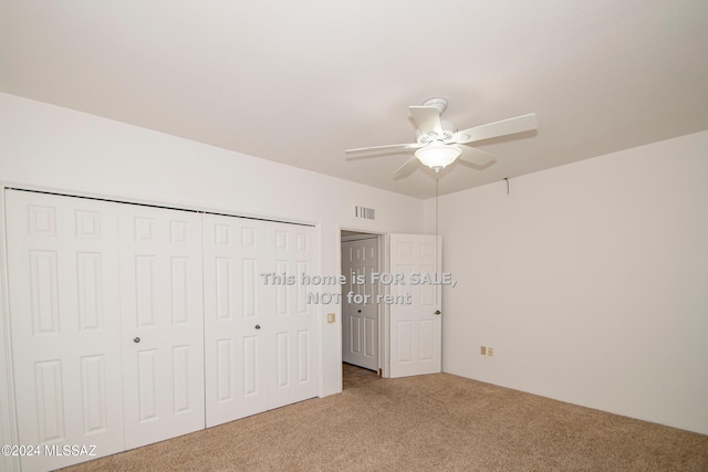 unfurnished bedroom featuring ceiling fan, a closet, carpet, and visible vents