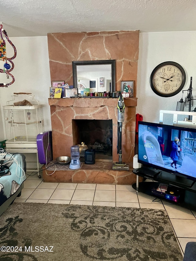 living room featuring tile patterned floors, a fireplace, and a textured ceiling