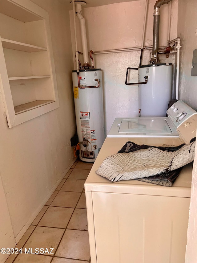 laundry area featuring washer and dryer, light tile patterned floors, and gas water heater