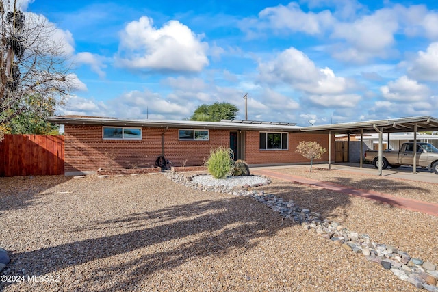 single story home featuring a carport