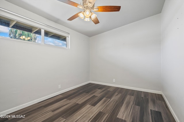 spare room featuring ceiling fan and dark hardwood / wood-style floors